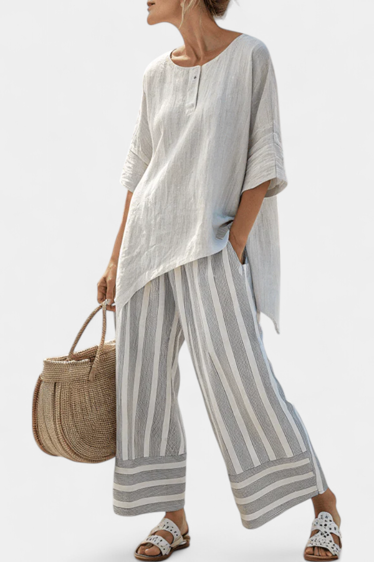 Komplett Daisy med Asymmetrisk Blus och Randiga Byxor för en Modern och Elegant Stil